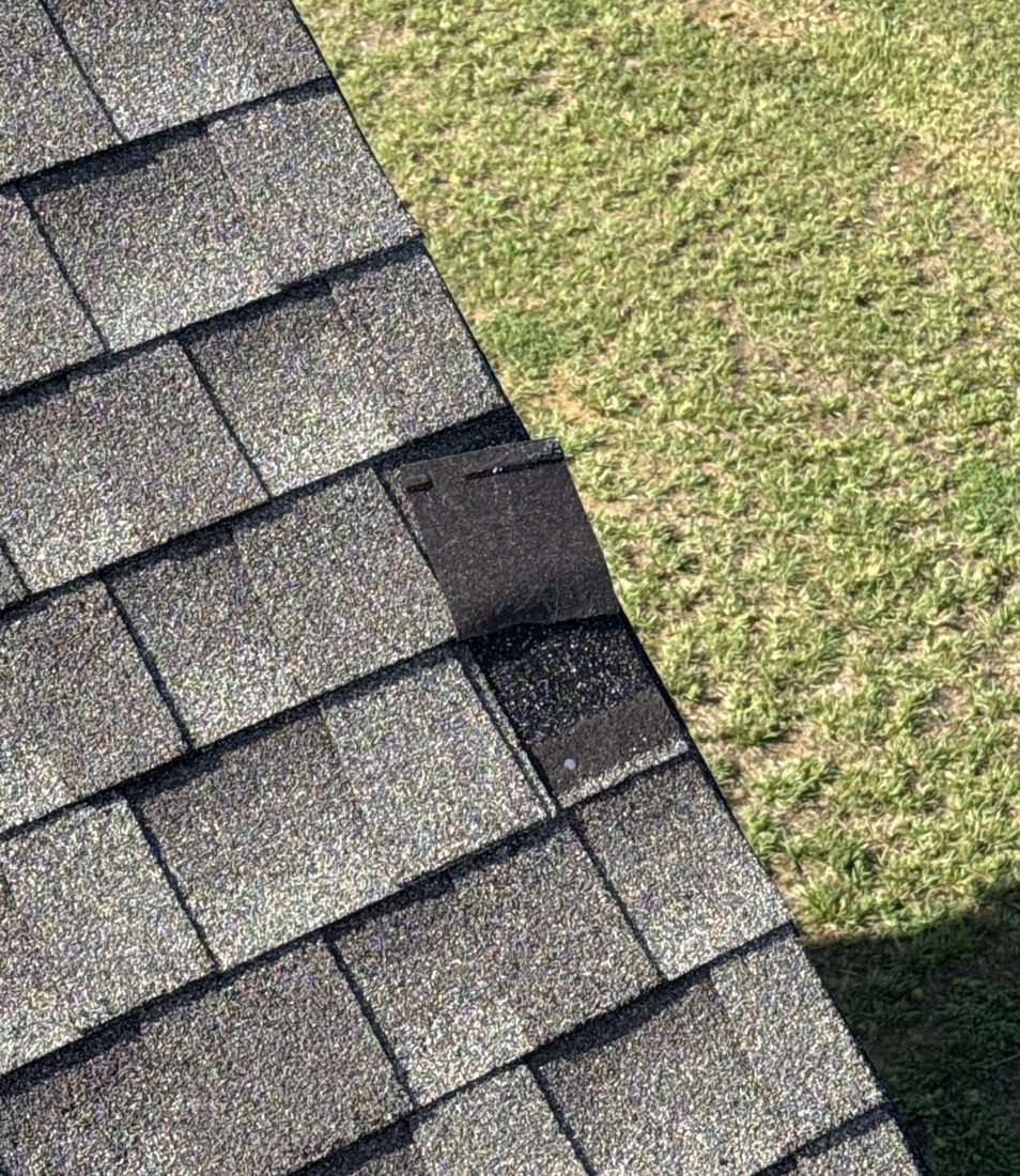 Drone photo of a mismatched shingle repair at a roof edge found during an aerial inspection